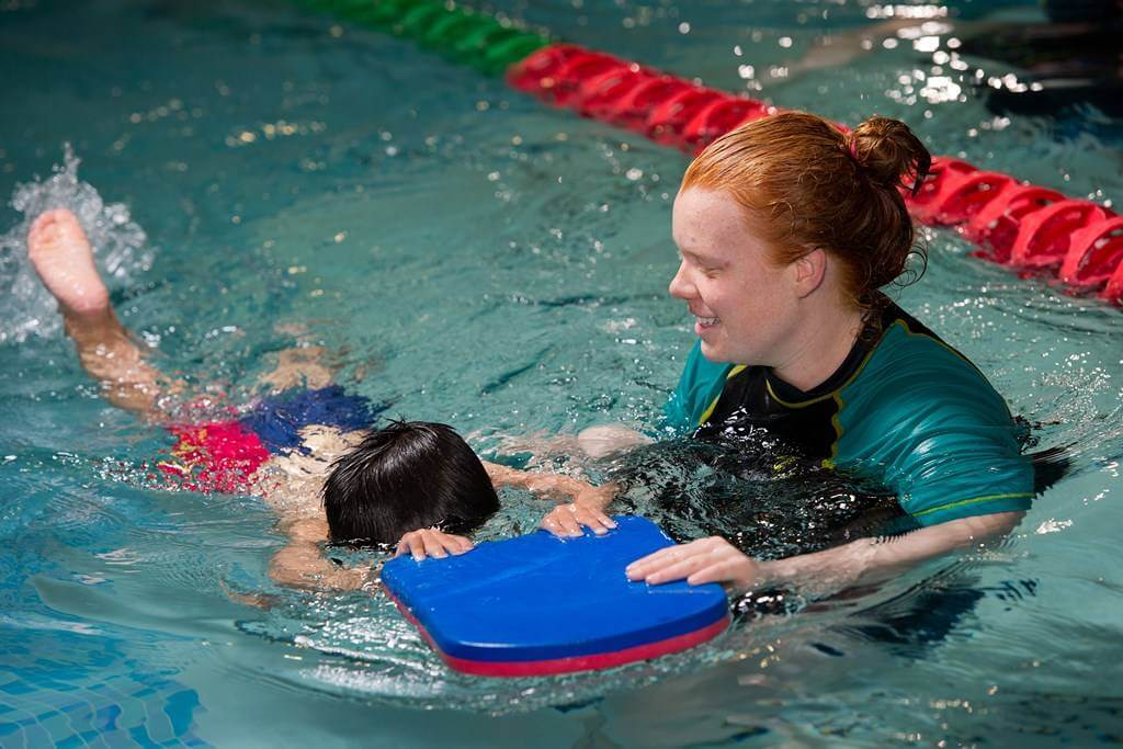 Swimmers underwater in lanes