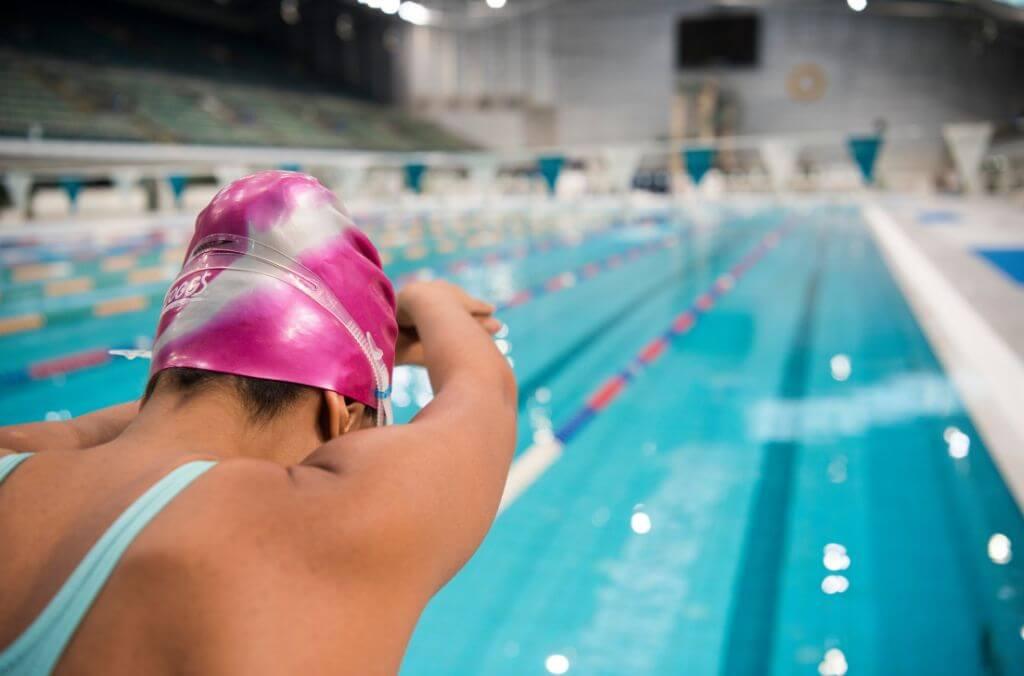 Image of person diving into Olympic sized pool